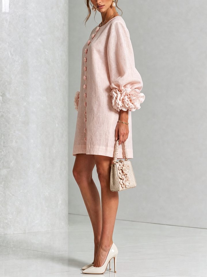 Side view of the light pink dress with puff sleeves, worn with cream heels and a small handbag 20
