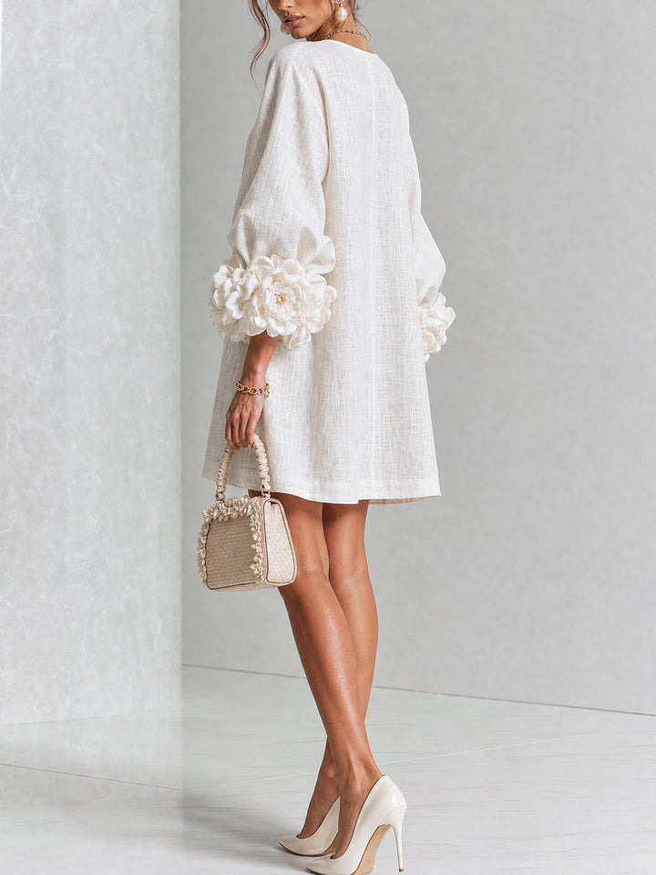Back view of the cream dress, showing the plain back and large rose cuffs on the sleeves 3