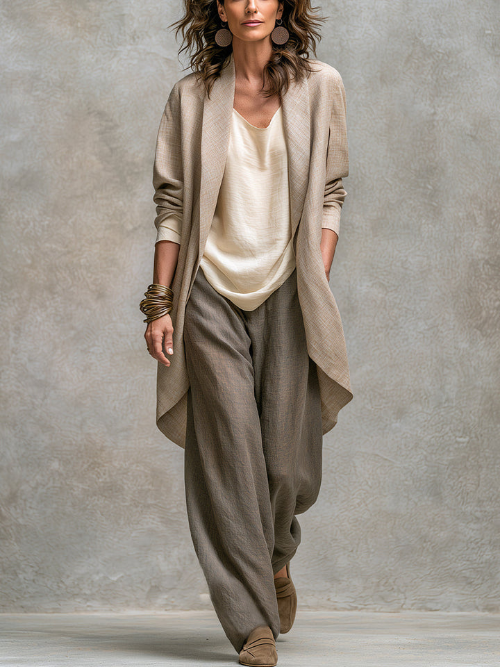 Full-length front view of a model wearing the open beige linen-look cardigan over a cream top and loose taupe wide-leg pants.