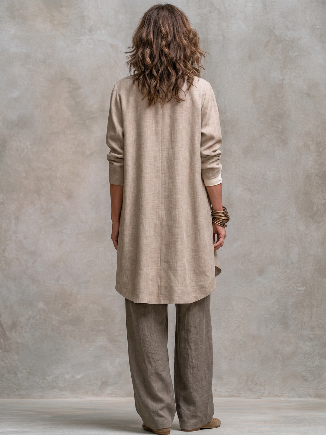 Beige long jacket with a center back seam and curved hem, another view.
