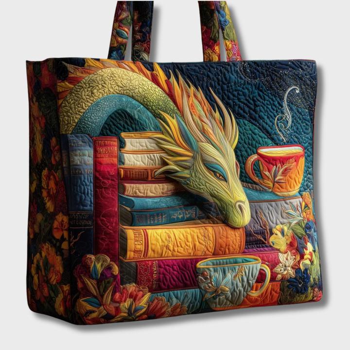 Quilted tote, another view, against a plain light gray background with the dragon, colorful book stack, teacup, floral side panel and patterned handles