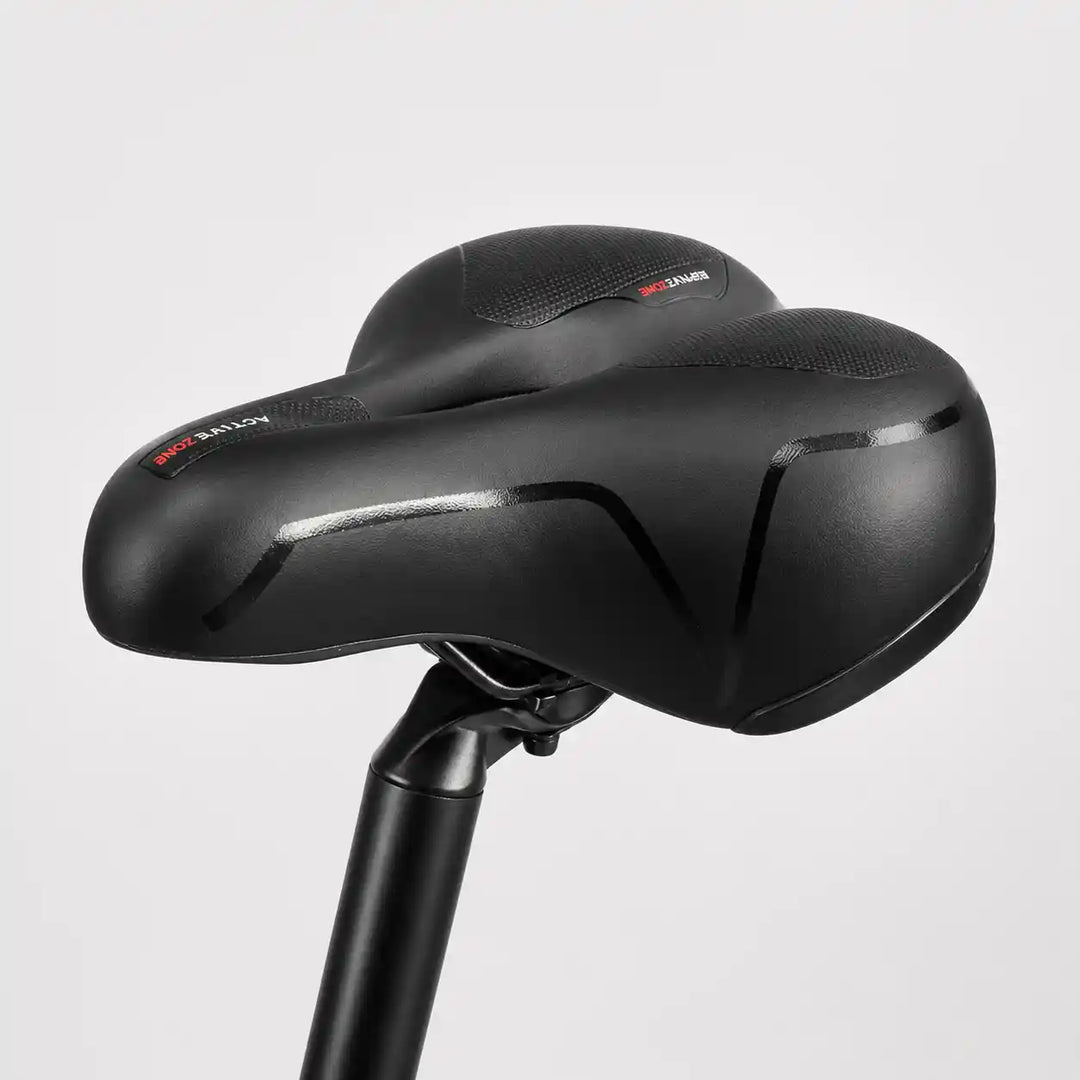 Side view of the saddle on a seatpost, showing its smooth cover and wide rear.