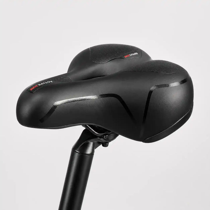 Side view of the saddle on a seatpost, showing its smooth cover and wide rear.