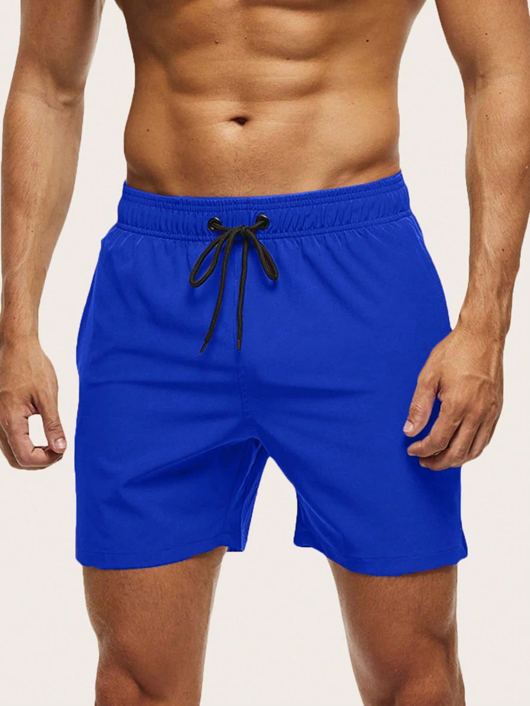 Men's swim trunks in bright blue on a model, front view with black drawstring and elastic waistband.