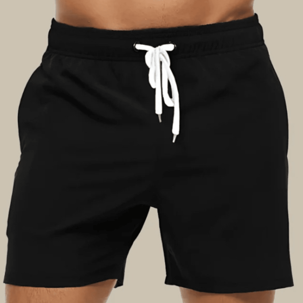 Black swim trunks with a white drawstring and elastic waistband, front view.