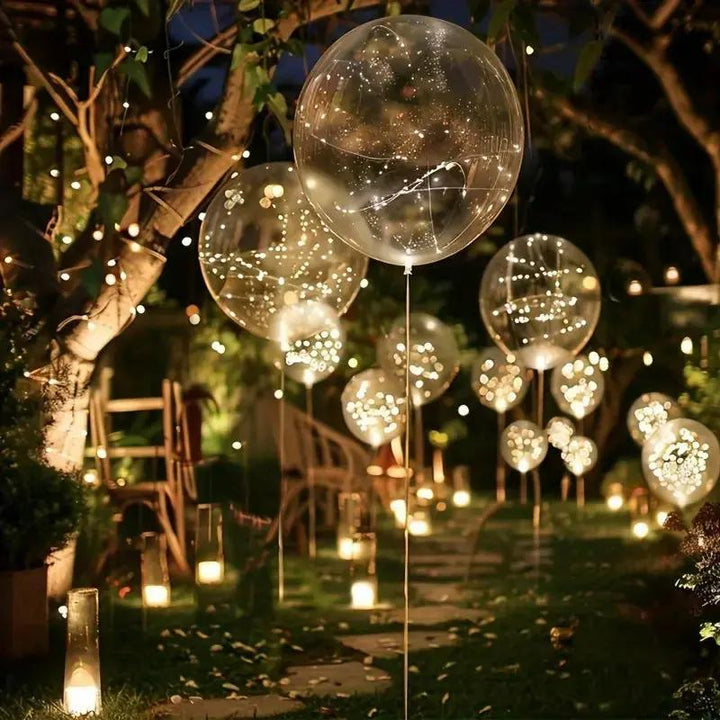 LED Balloon Set (10 Pack) another view of lit balloons along a garden path at night