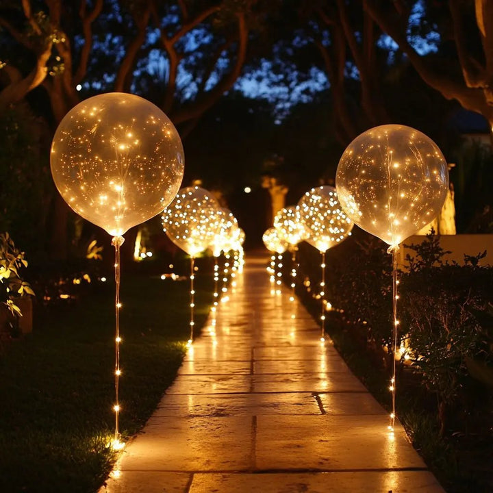 LED Balloon Set (10 Pack) warm white balloons along a garden path at night