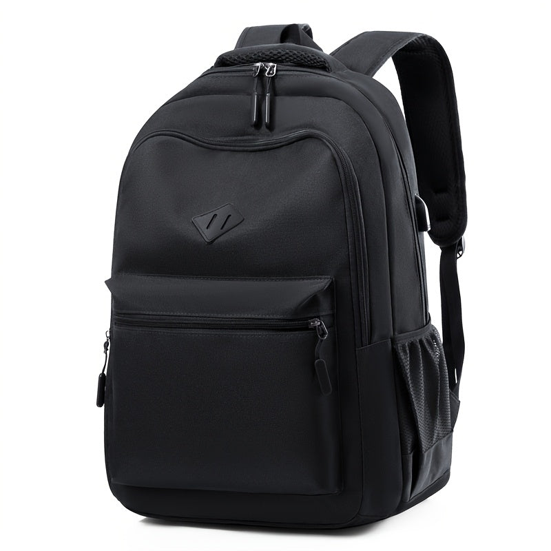 Black backpack seen from the front at an angle, with a large zippered front pocket, a mesh side pocket and padded straps. 4