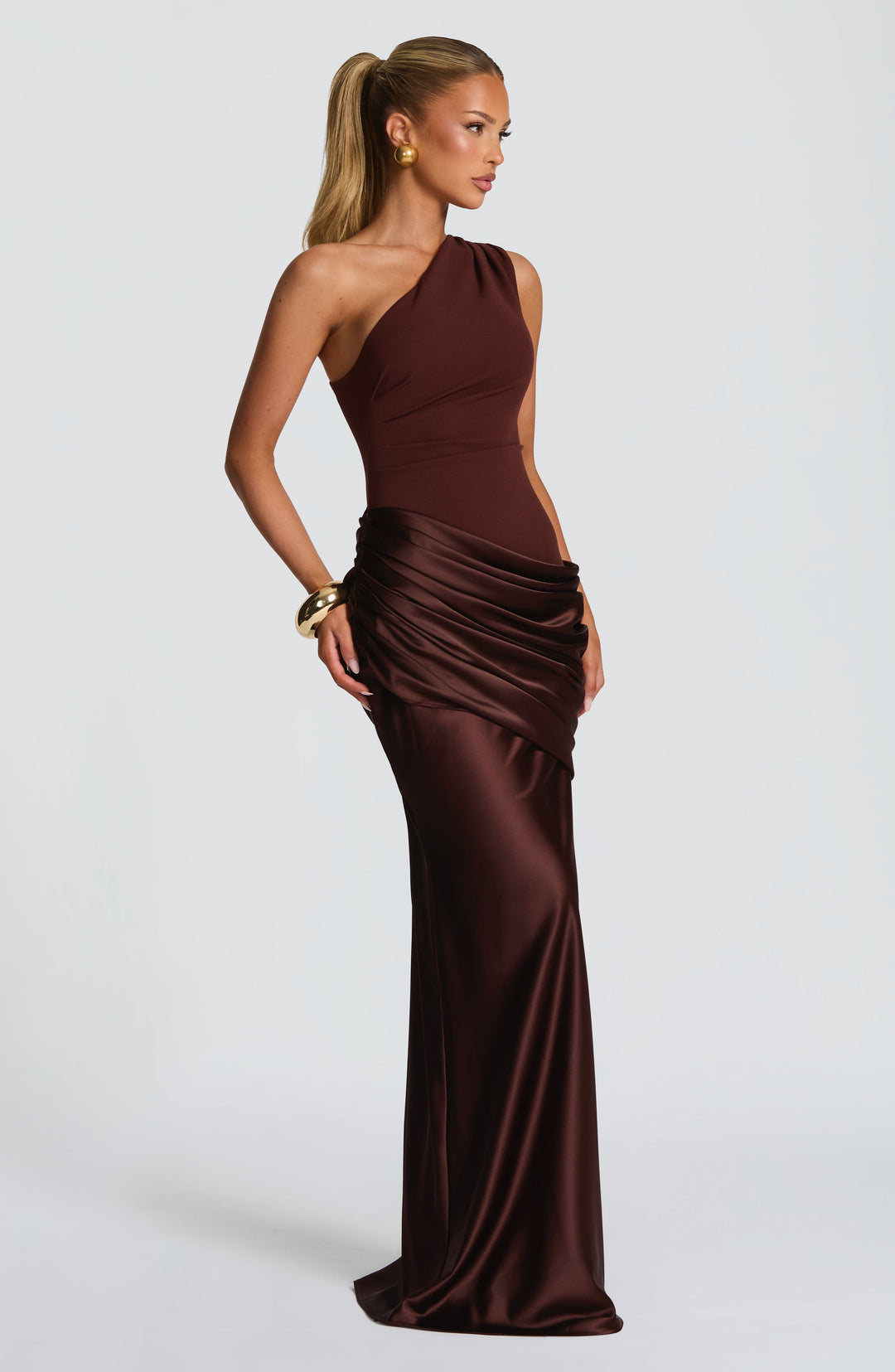 Side view of the brown one-shoulder gown, showing the gathered satin hip drape and long fitted skirt. 8