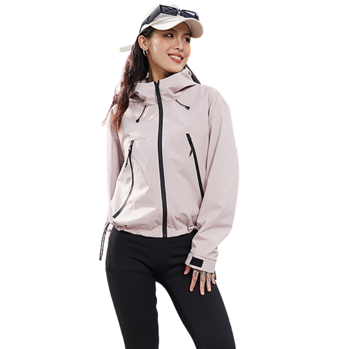 Light pink jacket with the hem drawcord gathered, model smiling and looking to the side with sunglasses resting on her cap. 10