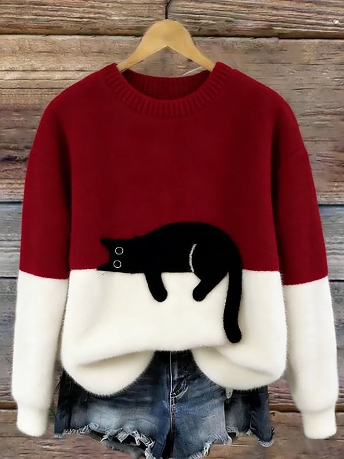 Red and white fuzzy colorblock sweater with a black cat stretched across the front, displayed on a hanger with denim shorts. 7
