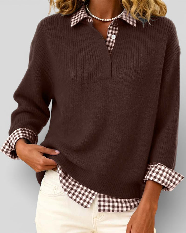 Brown ribbed knit sweater detail with one hand at the hem and brown gingham shirt peeking out below.