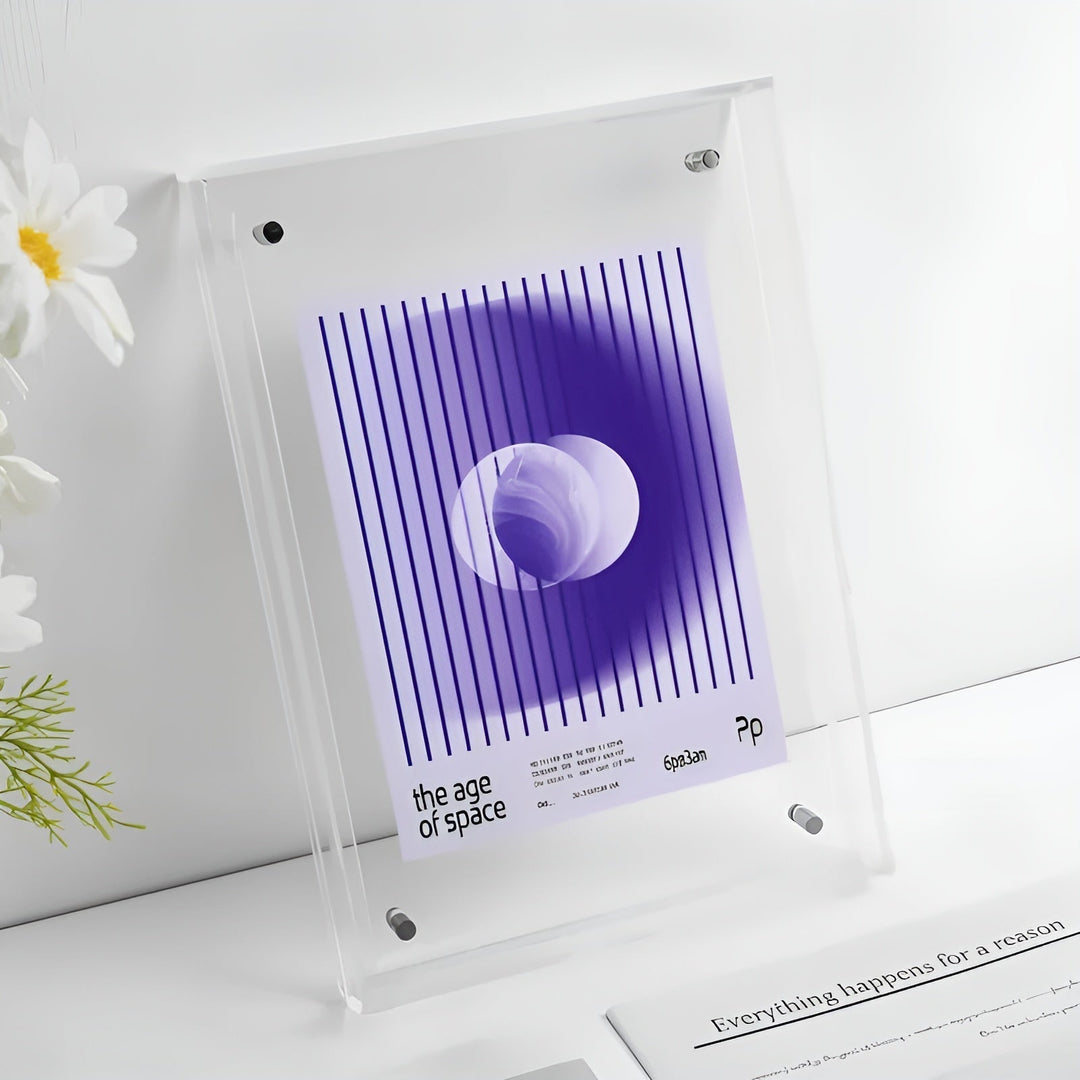 Clear acrylic frame with beveled edges standing beside white flowers.