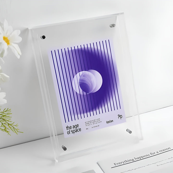 Clear acrylic frame with beveled edges standing beside white flowers.