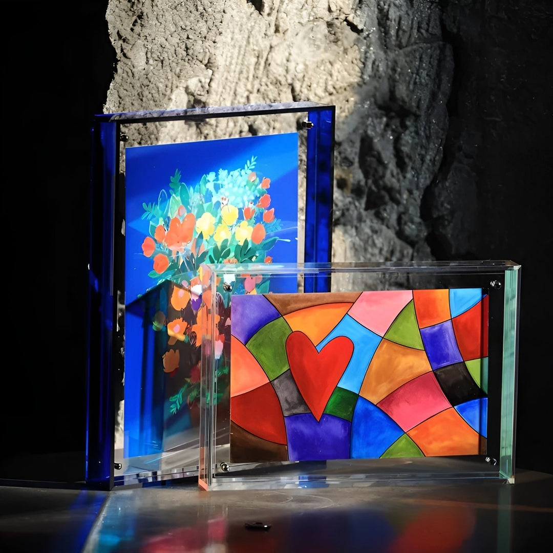 Another view of acrylic frames in blue and clear against a rough stone wall.