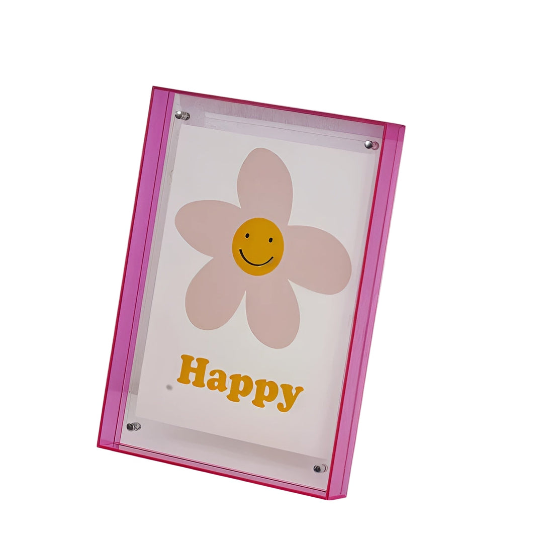 Hot pink acrylic frame with clear panel and corner studs holding a smiley flower print.