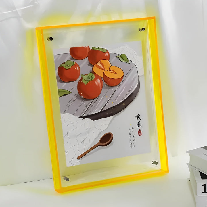 Yellow-edged acrylic frame leaning against a light wall.