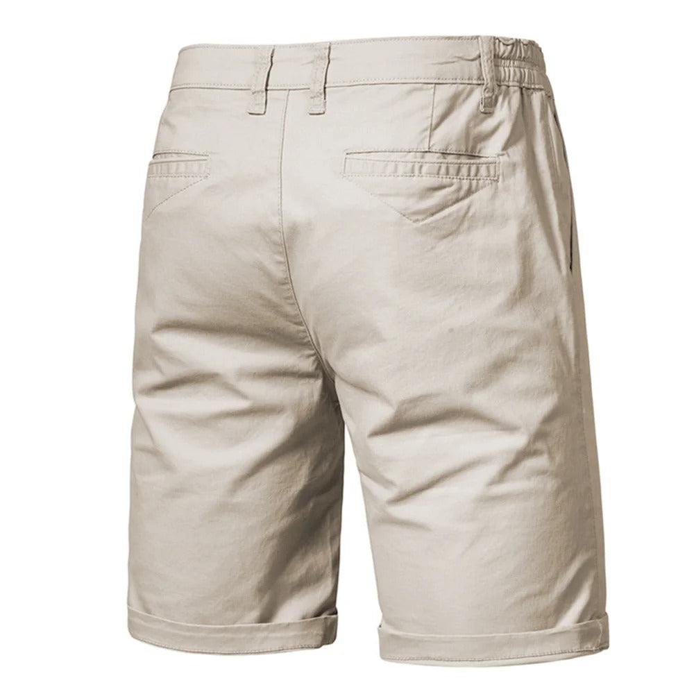 Back view of beige shorts showing two welt back pockets, belt loops and an elastic waist 2