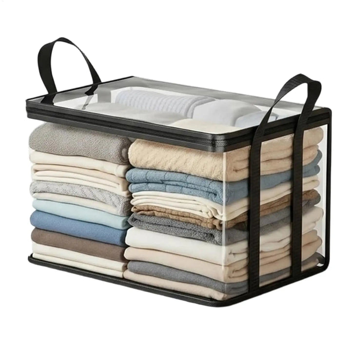 Clear storage bag with black trim, zipper and two handles, packed with folded blankets and clothes.