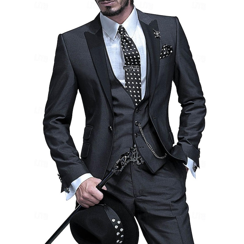 Men's three-piece suit in charcoal with black peak lapels, polka-dot tie, vest chain, cane and hat.