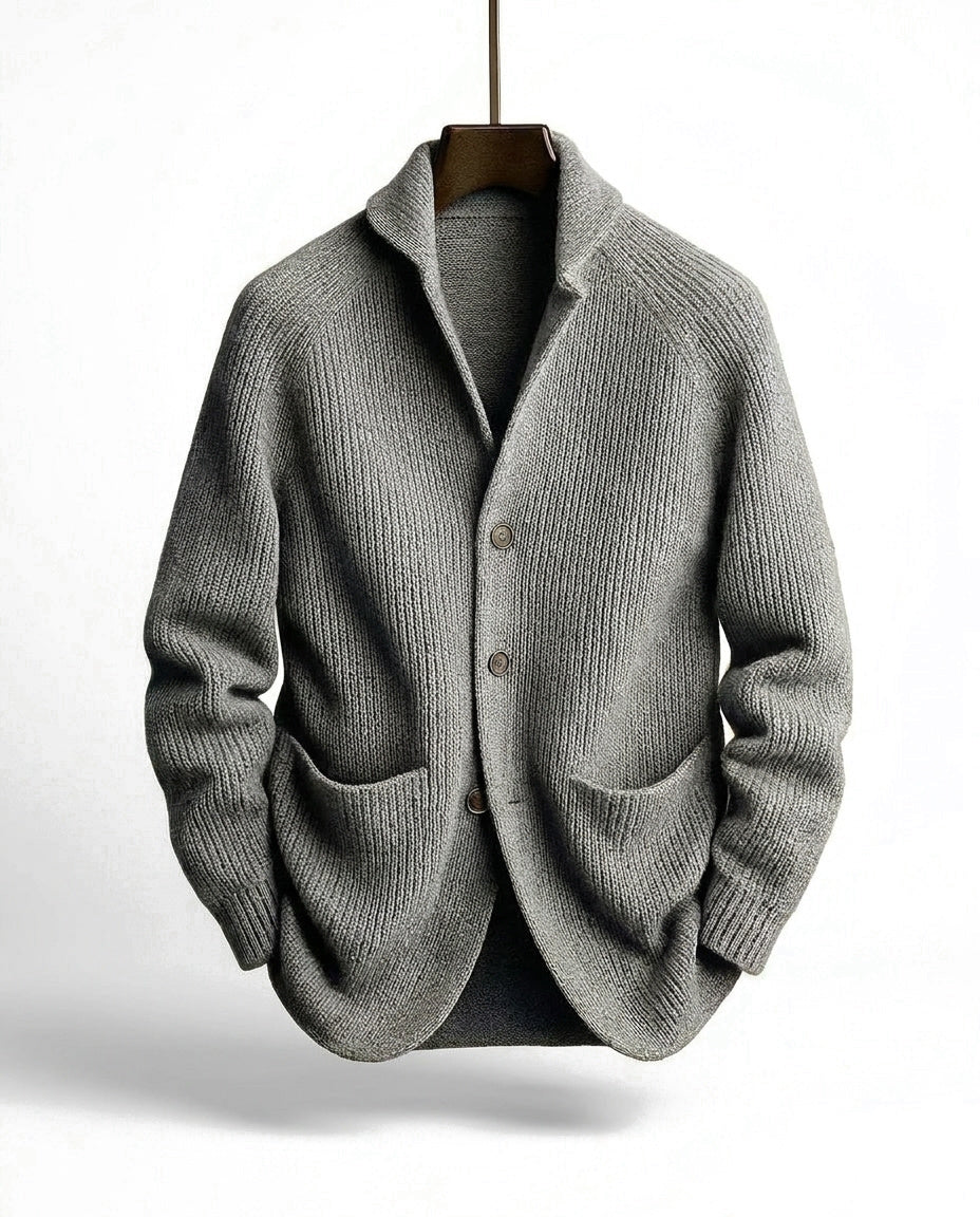 Gray version of the ribbed cardigan with three buttons and two front pockets, hanging on a wooden hanger 4