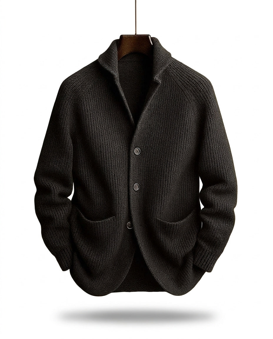 Charcoal black version of the ribbed cardigan hanging on a wooden hanger above a soft shadow 2