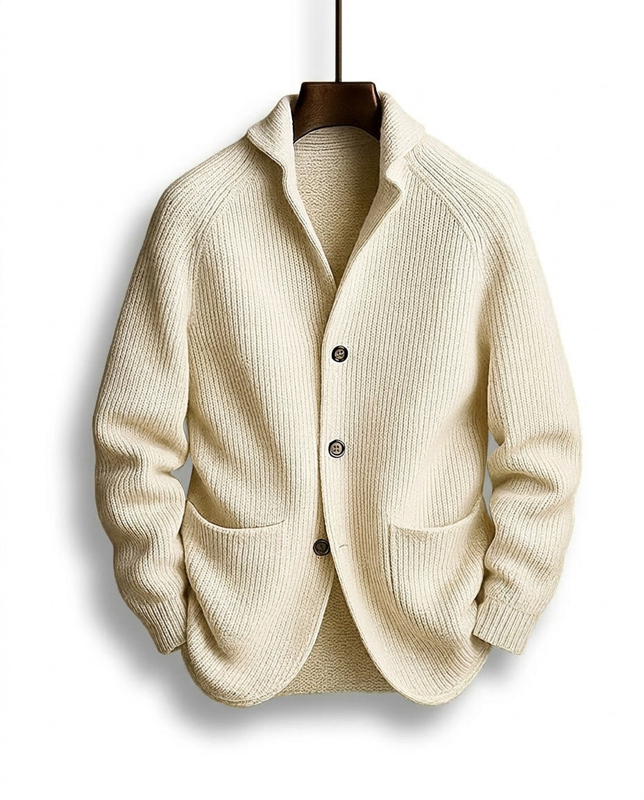 Cream version of the ribbed cardigan with dark buttons and a shawl collar, hanging on a wooden hanger 5
