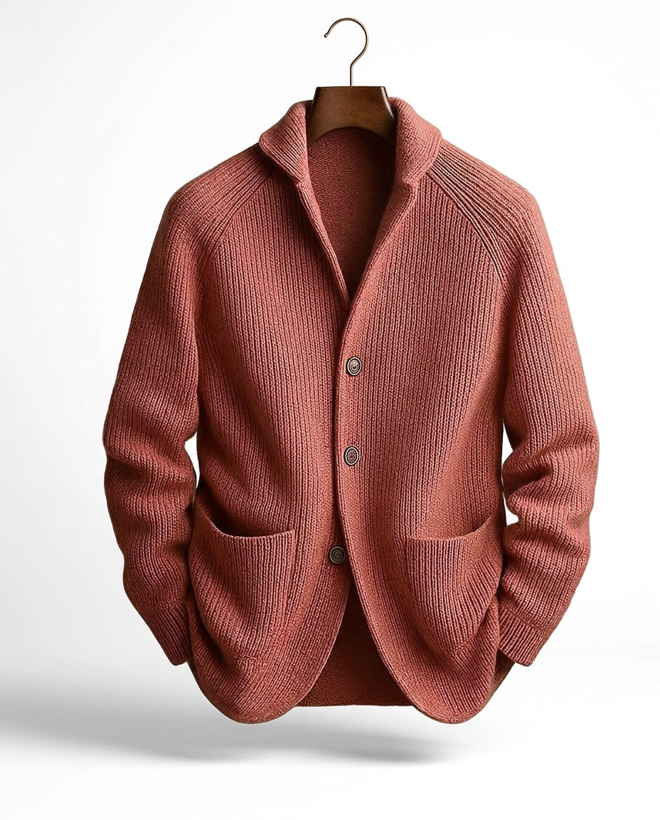 Terracotta red version of the ribbed cardigan with raglan sleeves and two patch pockets on a hanger 6