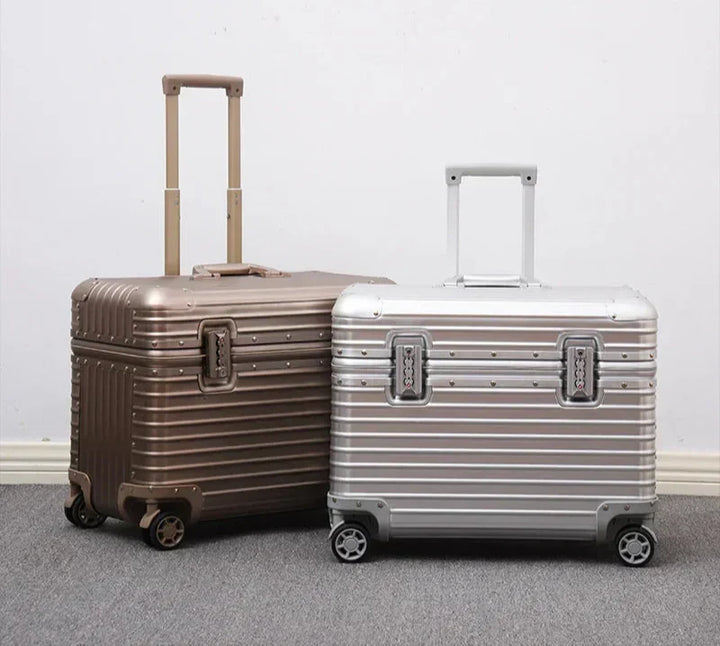 Champagne gold and silver suitcases with extended handles standing side by side against a white wall 7