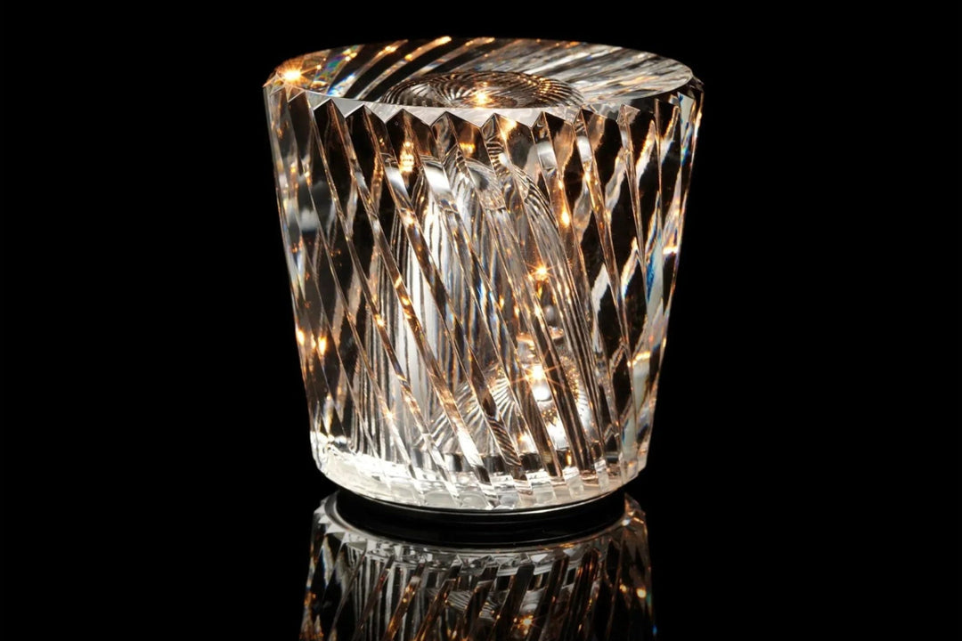 Gold transparent crystal table lamp, another view, with diagonal spiral facets glowing warmly.