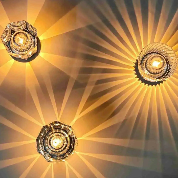 Gold transparent crystal table lamp, another view, showing three lit faceted styles from above.