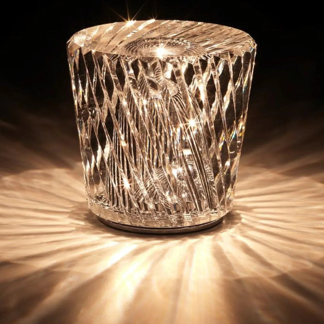 Gold transparent crystal table lamp, another view, with spiral facets and starburst highlights.