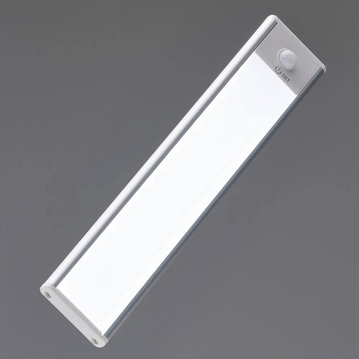 Close-up of the slim light bar at an angle, showing its round motion sensor and small power icon at one end. 7