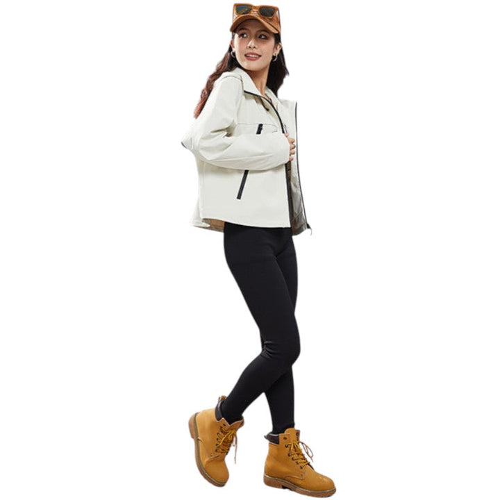 Full-length side view of the cream jacket with black leggings and tan boots, model smiling over her shoulder. 8