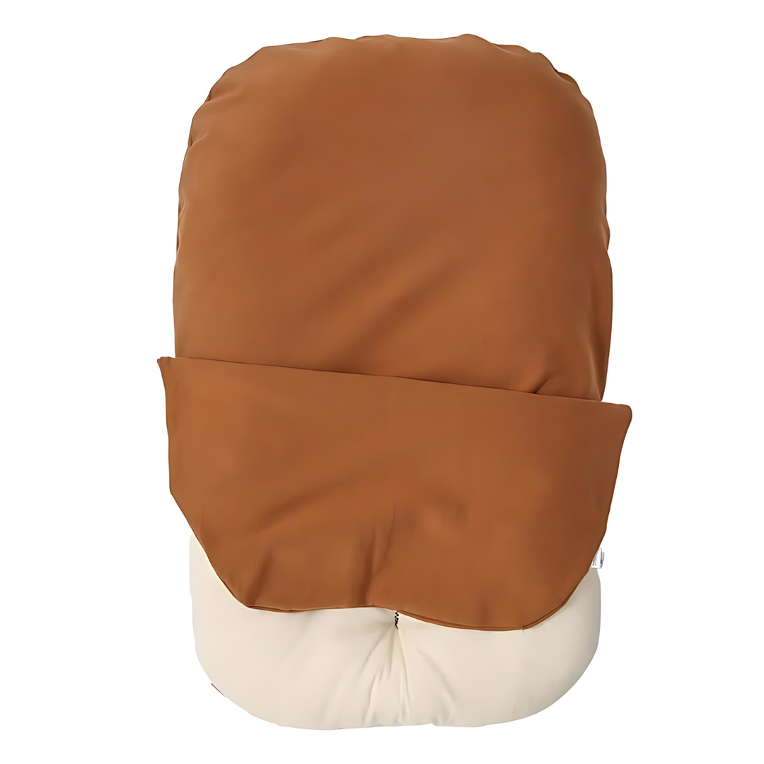Empty lounger with a brown cover partly pulled back to reveal the cream inner cushion 9