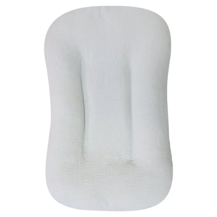 Empty pale gray crinkled cotton lounger with a recessed center and raised sides, top view 11