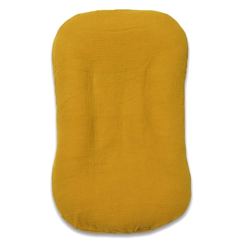Empty mustard-yellow crinkled cotton nest cushion photographed flat from above 12