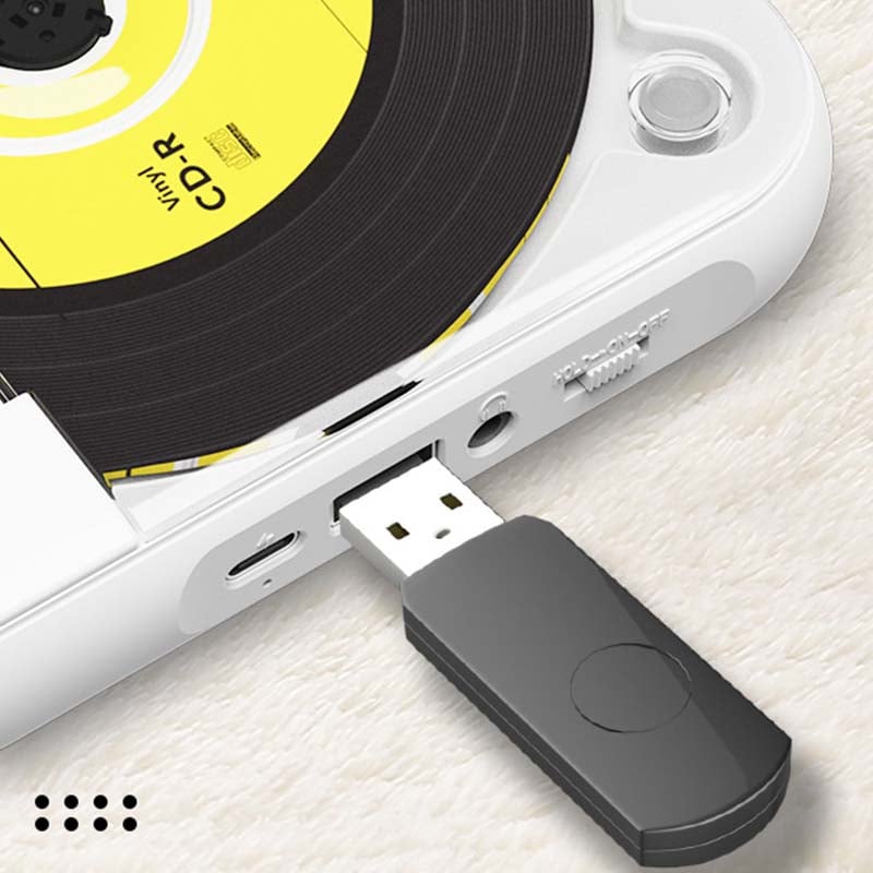 Close-up of the player's side with a black USB drive plugged into the port beside the headphone jack 9
