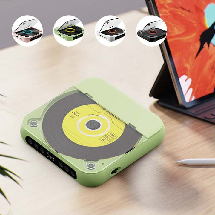 Green player with lid closed on a desk beside a tablet, with small thumbnails of the four colors above 6