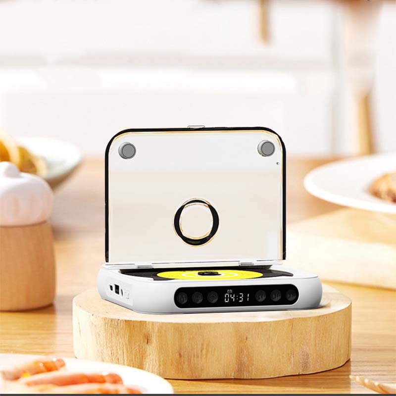 White player standing on a wooden slice on a dining table, lid open, front buttons and clock display visible 7