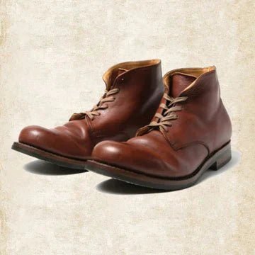 Men's brown leather lace-up boots with thick stitched soles, shown at an angle.
