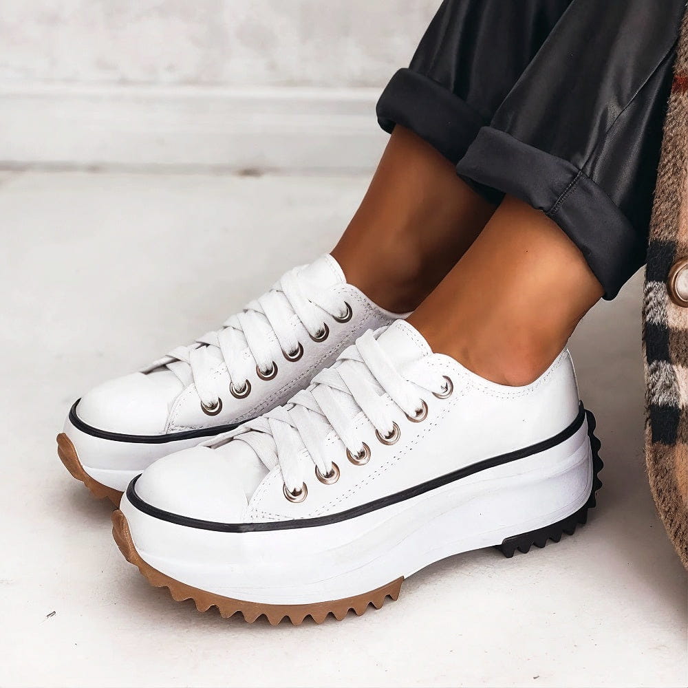 Bettina white platform sneakers with a thin black stripe on the chunky midsole and gum outsole.