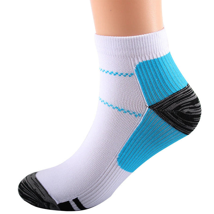White ankle sock on a foot form with blue ribbed arch and heel panels and dark gray heel and toe, another view. 5