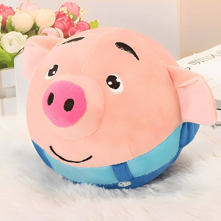 Pink pig plush ball with blue overalls resting on a soft white rug beside flowers.
