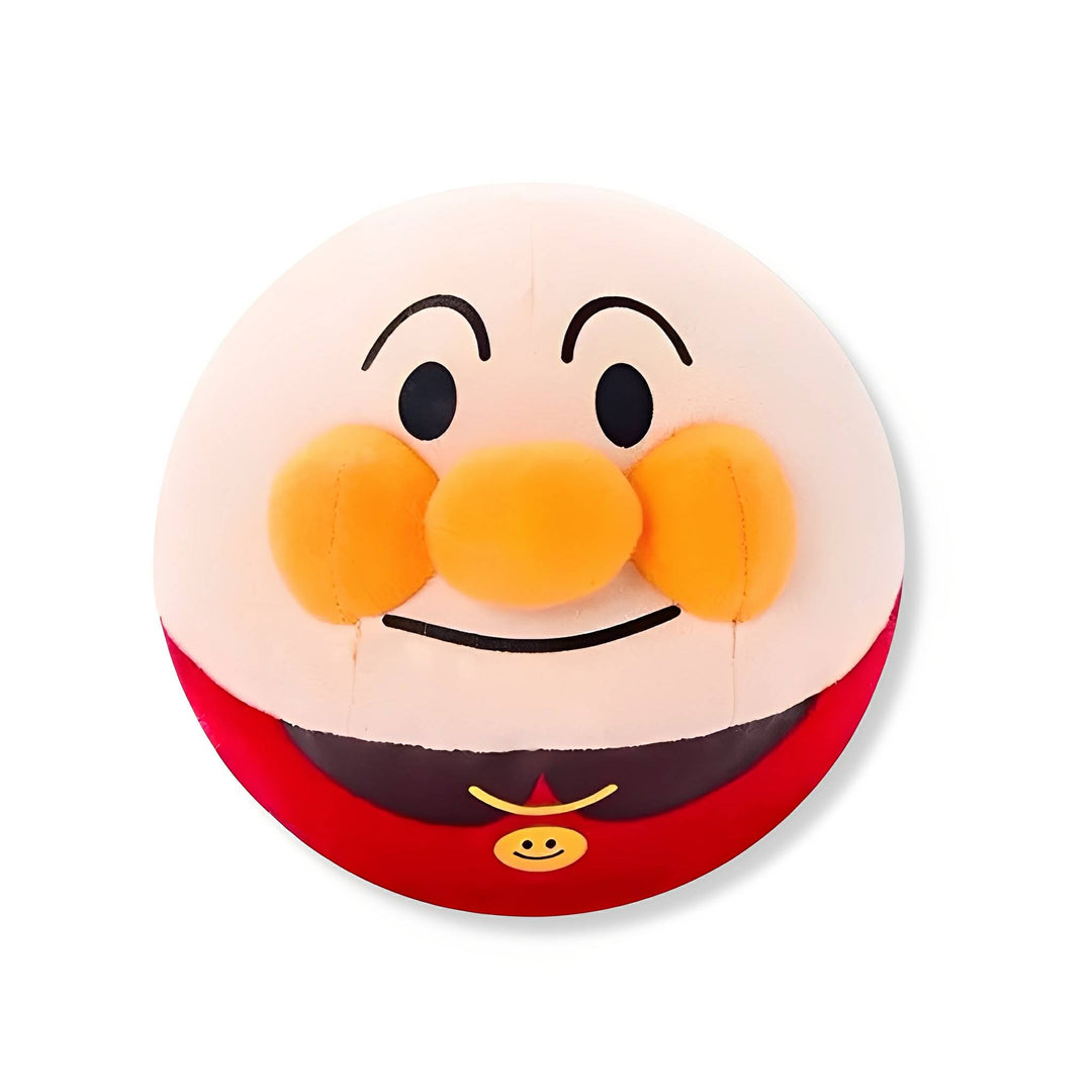 Front view of the round plush ball with a smiling white face, orange cheeks and nose, and red body on a white background.