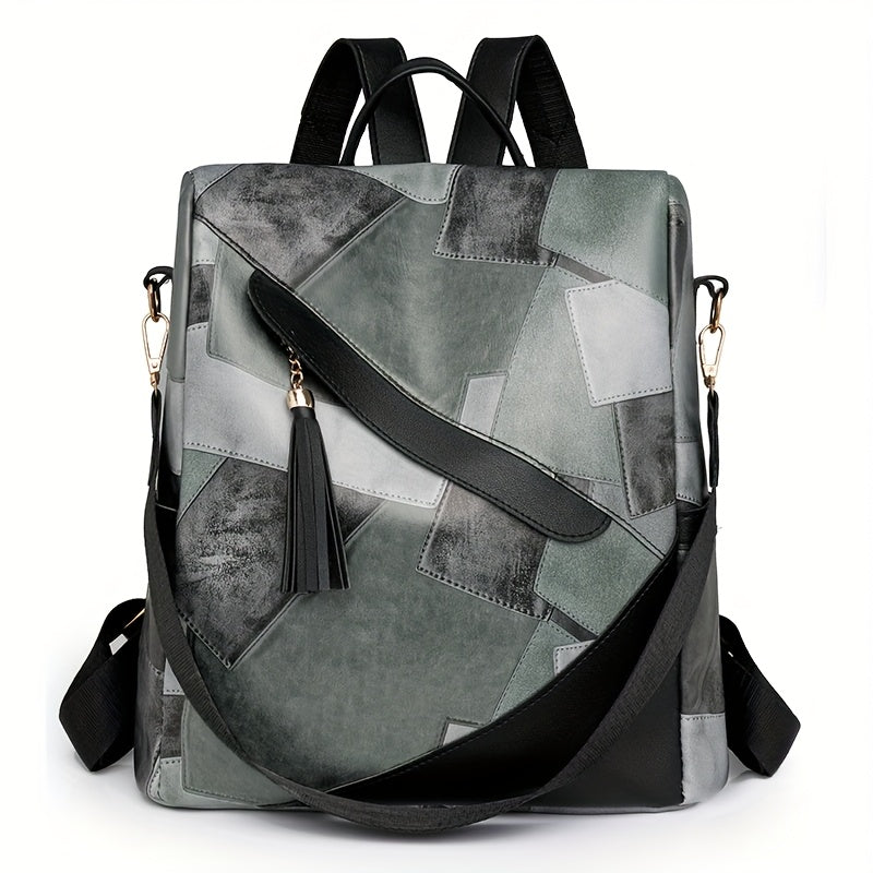 Front view of the gray patchwork backpack with a black diagonal strap, tassel, gold clasps and a removable crossbody strap. 5