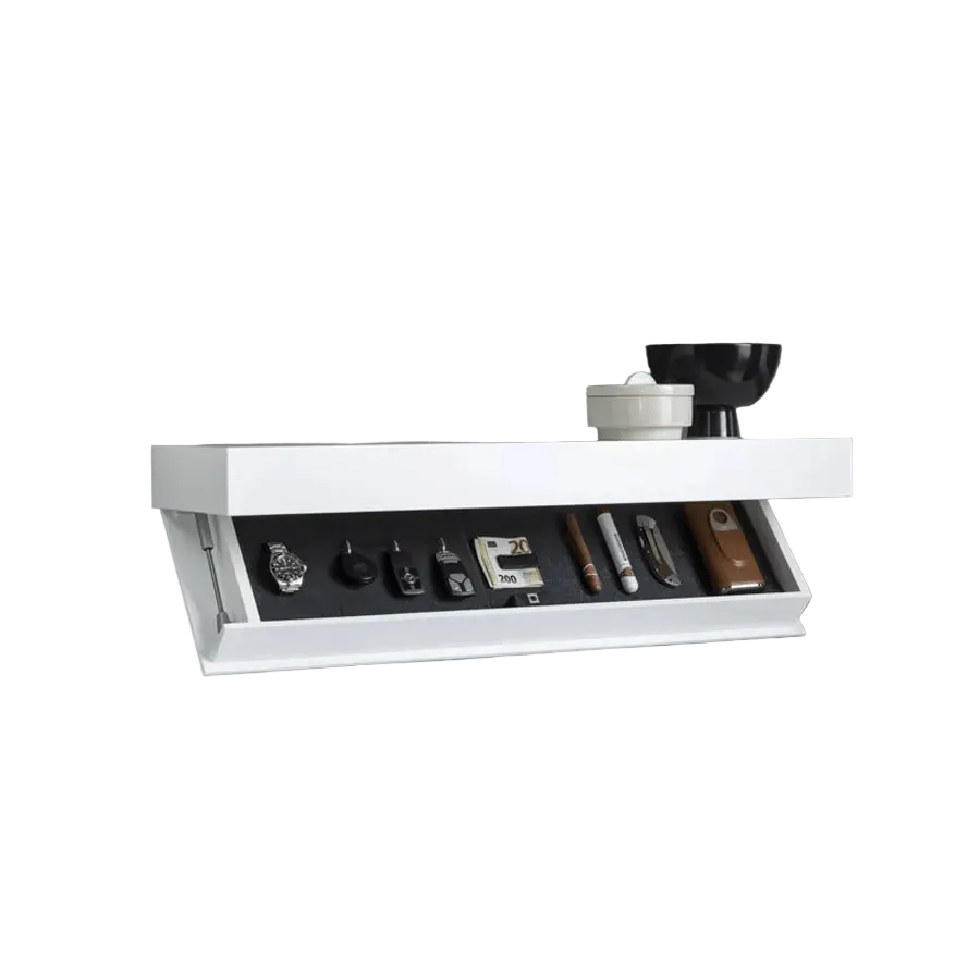 White floating shelf with a bowl and canister on top and its compartment open, revealing a watch, keys, cash, a cigar and a knife. 2