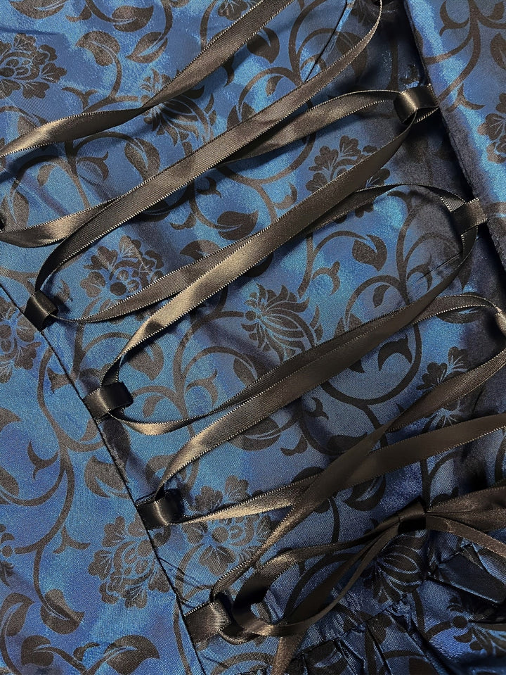 Women's gothic vampire costume dress fabric detail with black lacing.