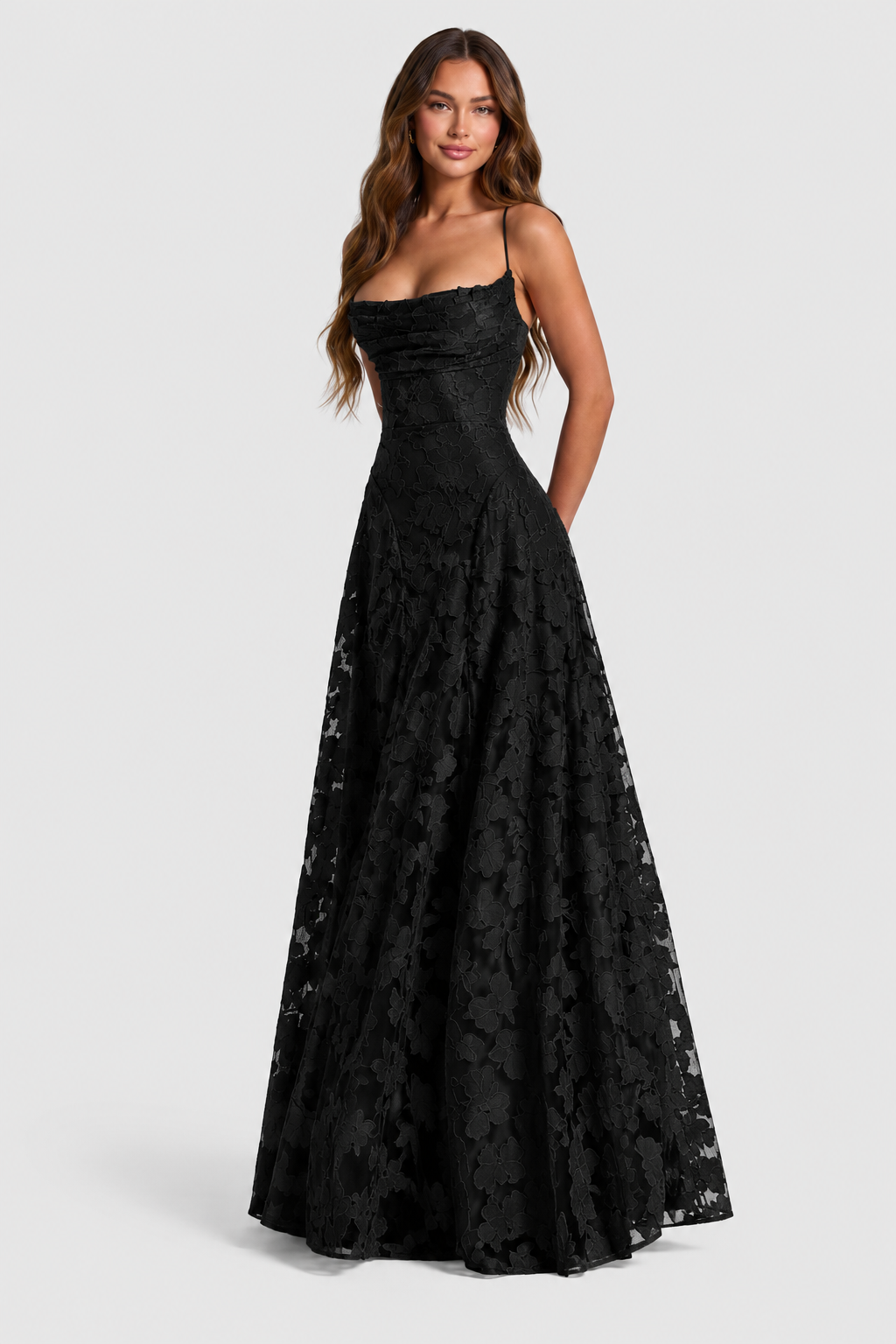 Black floral lace dress with a draped neckline and thin straps, shown from the front.