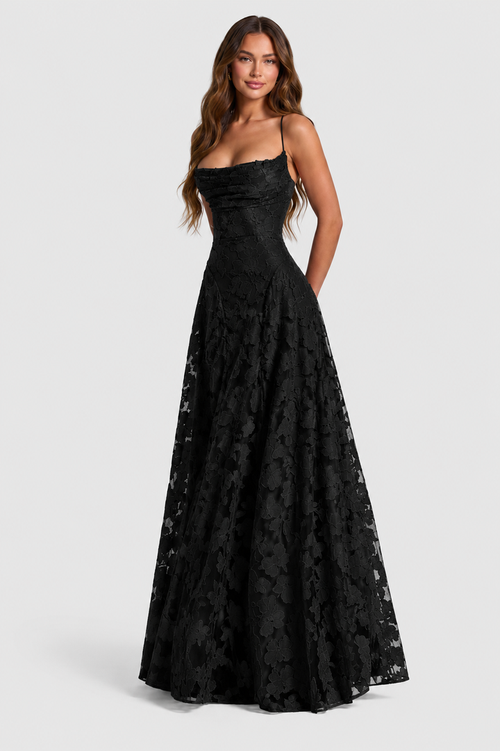 Model wearing the black floral lace A-line dress with thin straps and draped cowl neckline, shown in a full-length three-quarter front view. 21